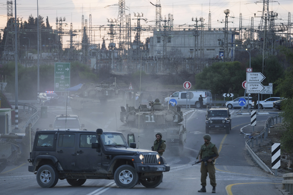 Israeli tanks move near the Israeli Gaza border, Israel, Wednesday, Oct. 11, 2023.