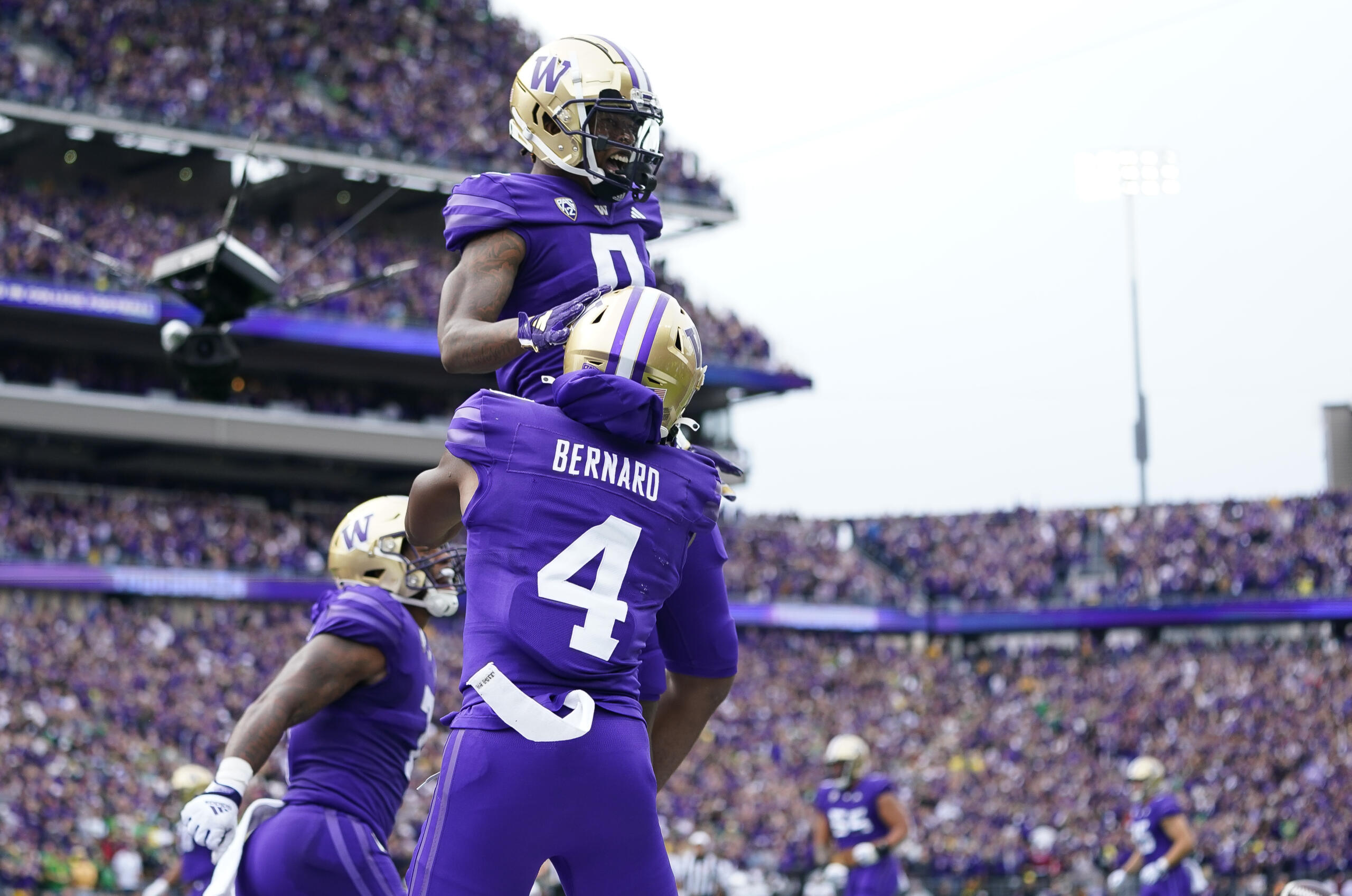 Washington wide receiver Giles Jackson, top, is lifted up by wide receiver Germie Bernard (4) after scoring a touchdown against Oregon during the first half of an NCAA college football game, Saturday, Oct. 14, 2023, in Seattle.