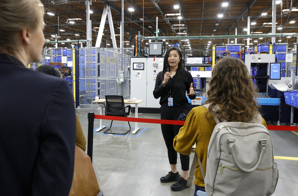 IMAGE DISTRIBUTED FOR AMAZON - Rain Wang, senior technical product manager, Amazon Robotics demonstrates Sequoia, a new robotic system at Amazon's Delivering the Future event in Sumner, WA on Wednesday, October 18, 2023.