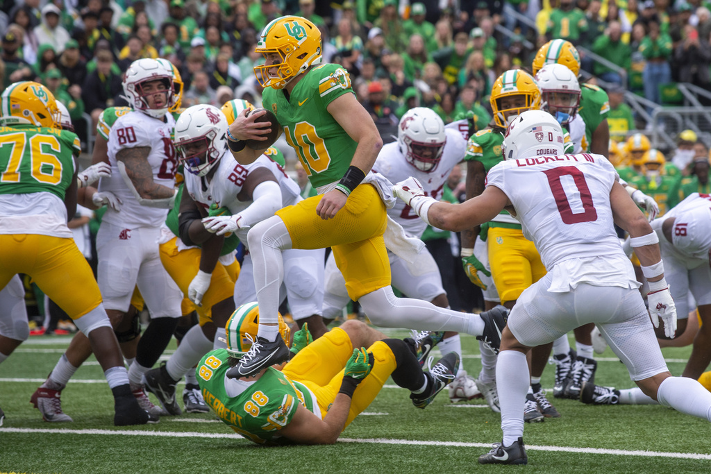 Oregon quarterback Bo Nix (10) scores a touchdown against Washington State during the first half of an NCAA college football game Saturday, Oct. 21, 2023, in Eugene, Ore.