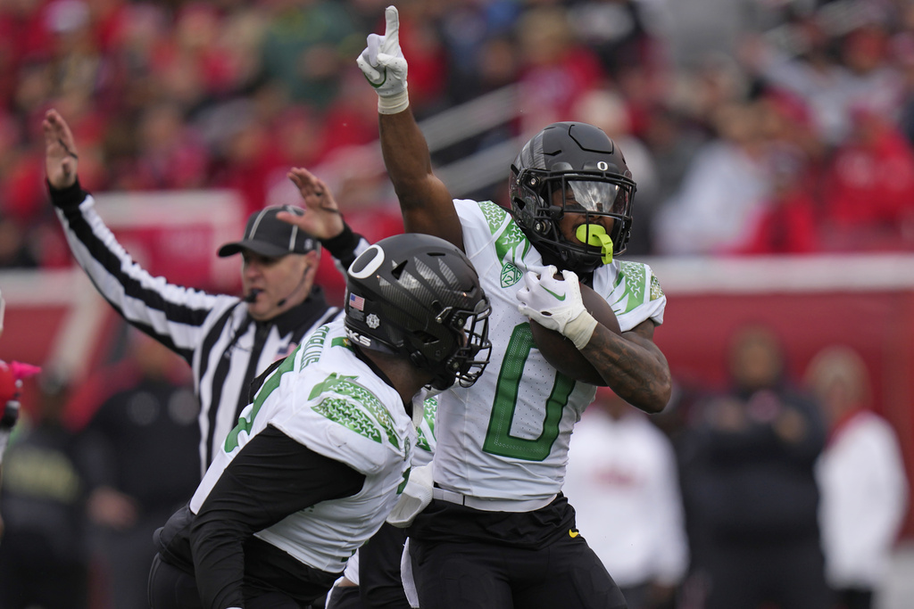 Oregon defensive back Tysheem Johnson (0) celebrates after making an interception against Utah during the first half of an NCAA college football game Saturday, Oct. 28, 2023, in Salt Lake City.