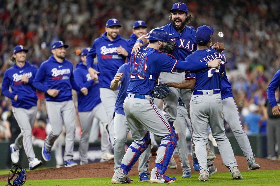 The Texas Rangers celebrate after Game 7 of the baseball AL Championship Series against the Houston Astros Monday, Oct. 23, 2023, in Houston. The Rangers won 11-4 to win the series 4-3. (AP Photo/David J.