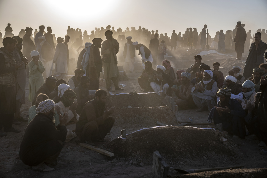 Afghans bury hundreds of people killed in an earthquake to a burial site, in a village in Zenda Jan district in Herat province, western of Afghanistan, Monday, Oct. 9, 2023. Saturday's deadly earthquake killed and injured thousands when it leveled an untold number of homes in Herat province.