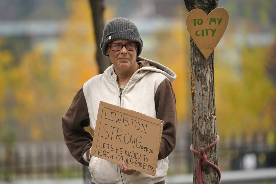 Jess Paquette expresses her support for her city in the wake of Wednesday's mass shootings at a restaurant and bowling alley, Thursday, Oct. 26, 2023, in Lewiston, Maine. Police continue their manhunt for the suspect. Authorities urged residents to lock themselves in their homes and schools announced closures on Thursday. (AP Photo/Robert F.