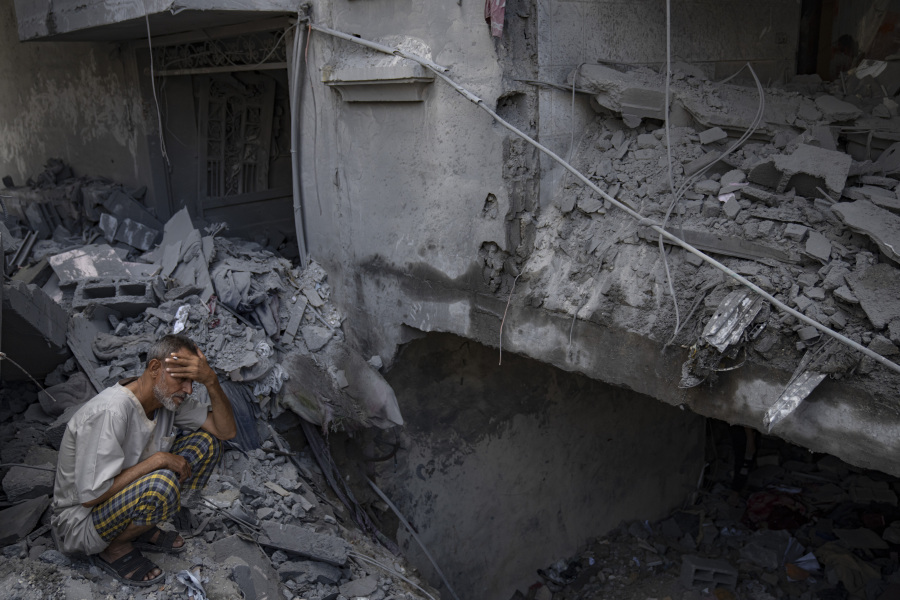 A man sits outside his building which was destroyed during Israeli bombardment in Rafah refugee camp in Gaza Strip on Tuesday, Oct. 17, 2023.