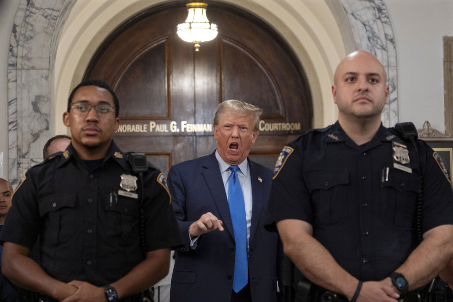 Former President Donald Trump speaks with journalists during a midday break from court proceedings in New York, Monday, Oct. 2, 2023, as he attends the start of a civil trial in a lawsuit that already has resulted in a judge ruling that he committed fraud in his business dealings.