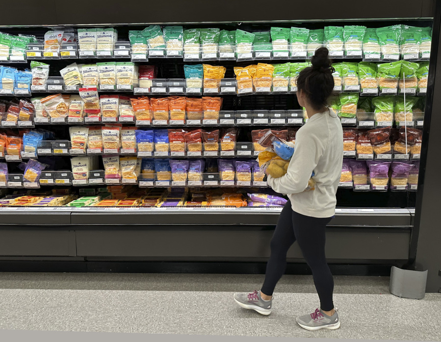 File - A shopper peruses cheese offerings at a Target store on Oct. 4, 2023, in Sheridan, Colo. On Thursday, the Labor Department issues its report on inflation at the consumer level. As household expenses outpace earnings, many are expressing concern about their financial futures.