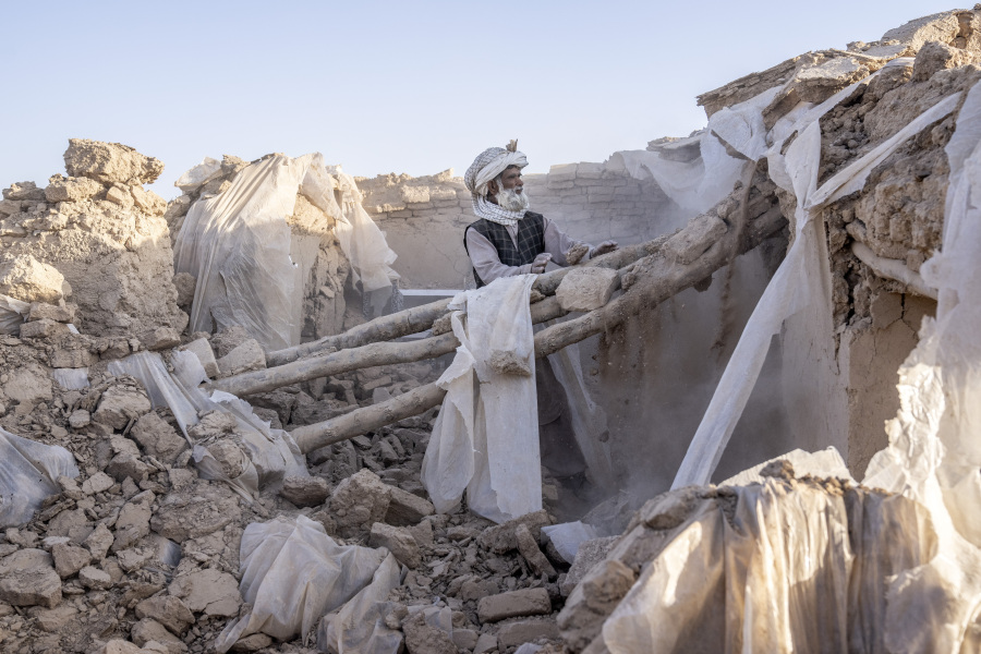 A man cleans up rubble after an earthquake in Zenda Jan district in Herat province, western Afghanistan, Wednesday, Oct. 11, 2023. Another strong earthquake shook western Afghanistan on Wednesday morning after an earlier one killed more than 2,000 people and flattened whole villages in Herat province in what was one of the most destructive quakes in the country's recent history.