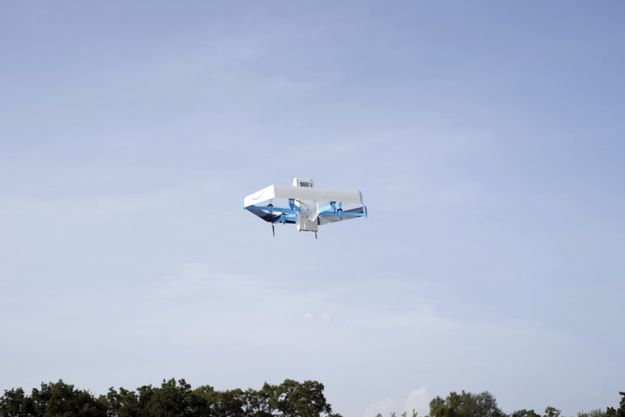 This photo provided by Amazon shows a drone delivering presciption drugs in College Station, Texas. Amazon will soon make prescription drugs fall from the sky when the e-commerce giant becomes the latest company to test drone deliveries for medications. The company said Wednesday, Oct. 18, 2023 that customers in College Station, Texas, can now get prescriptions delivered by a drone within an hour of placing their order.