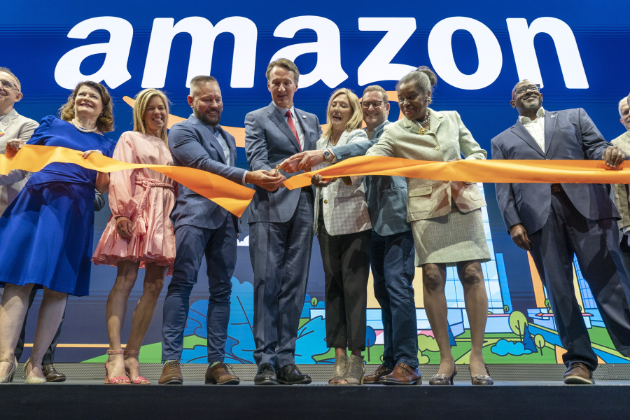 Virginia Gov. Glenn Youngkin, center, with Holly Sullivan, Vice President of Economic Development at Amazon, center right, cut the ribbon during a grand opening ceremony at Amazon's second headquarters, HQ2, in Arlington, Va., June 15, 2023.  Two new operations facilities are coming to Virginia Beach, expected to eventually employ over 1,000 people, Gov. Youngkin announced Monday, Sept. 25. From right, Christian Dorsey, Chair of the Arlington County Board of Directors, Lieutenant Gov. of Virginia Winsome Earle-Sears, John Schoettler, Vice President of Global Real Estate and Facilities at Amazon, Holly Sullivan, Gov. Glenn Youngkin, Brian Huseman, Vice President of Public Policy and Community Engagement at Amazon, Youngkin's wife Suzanne Youngkin and Virginia State Sen. Barbara Favola, D-Arlington.