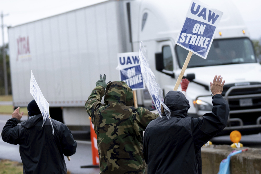 General Motors' Spring Hill union employees walk the picket line near the plant in Spring Hill, Tenn., Monday, Oct. 30, 2023. The union and GM have reached a tentative agreement on their contracts, but will remain on the picket line until the union bosses tell them otherwise.