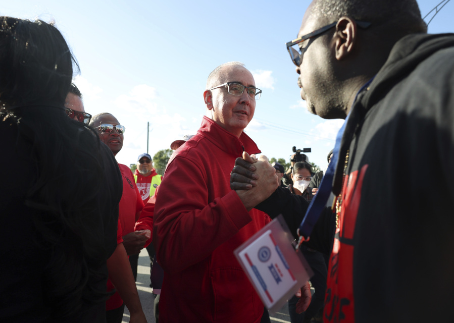 File - United Auto Workers President Shawn Fain, center, visits striking UAW Local 551 workers outside a Ford assembly center on South Burley Avenue on Oct. 7, 2023, in Chicago. Throughout its 5-week-old strikes against Detroit's automakers, the United Auto Workers union has cast an emphatically combative stance, reflecting the style of Fain, its pugnacious leader. (John J.