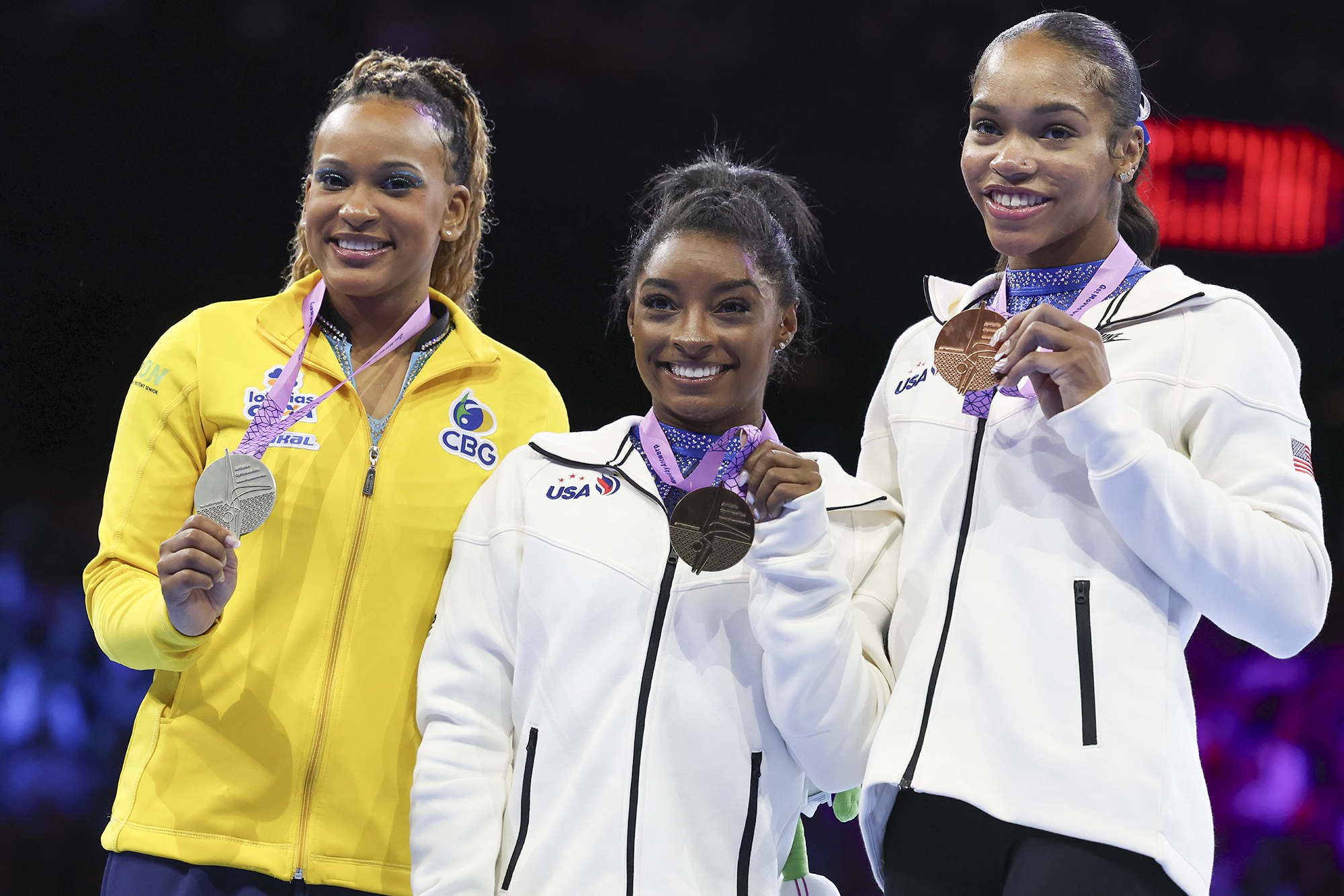 United States' Simone Biles, center and gold medal, Brazil's Rebeca Andrade, left and silver medal and United States' Shilese Jones, right and bronze medal, pose on the podium after the women's all-round final at the Artistic Gymnastics World Championships in Antwerp, Belgium, Friday, Oct. 6, 2023.