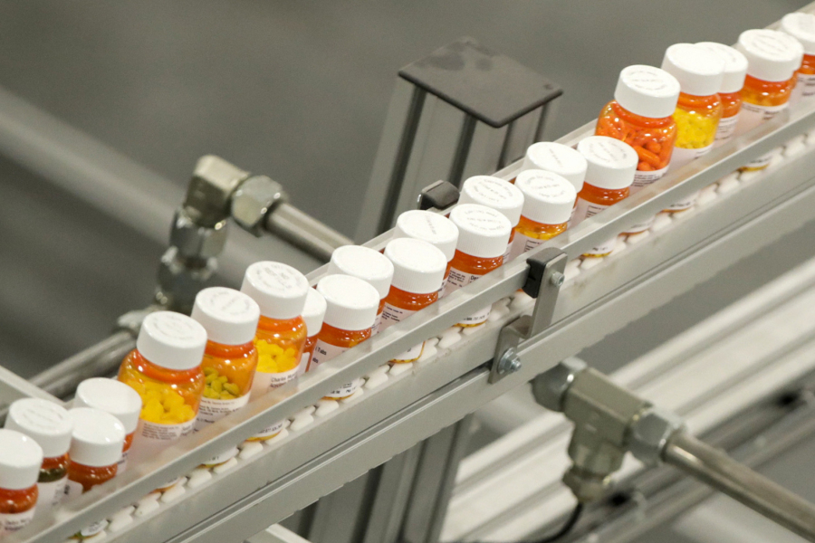 FILE- Bottles of medicine ride on a belt at a mail-in pharmacy warehouse in Florence, N.J., July 10, 2018. The Biden administration says the manufacturers of all of the first 10 prescription drugs it selected for Medicare's first price negotiations have agreed to participate. Tuesday's announcement clears the way for talks that could lower their costs in coming years and gives the White House a potential political win heading into next year's presidential election.