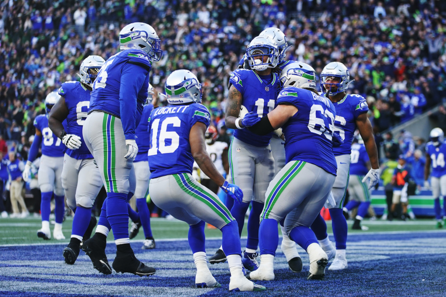 Seattle Seahawks wide receiver Jaxon Smith-Njigba, center, celebrates with teammates after scoring a touchdown late in the second half of an NFL football game against the Cleveland Browns, Sunday, Oct. 29, 2023, in Seattle.