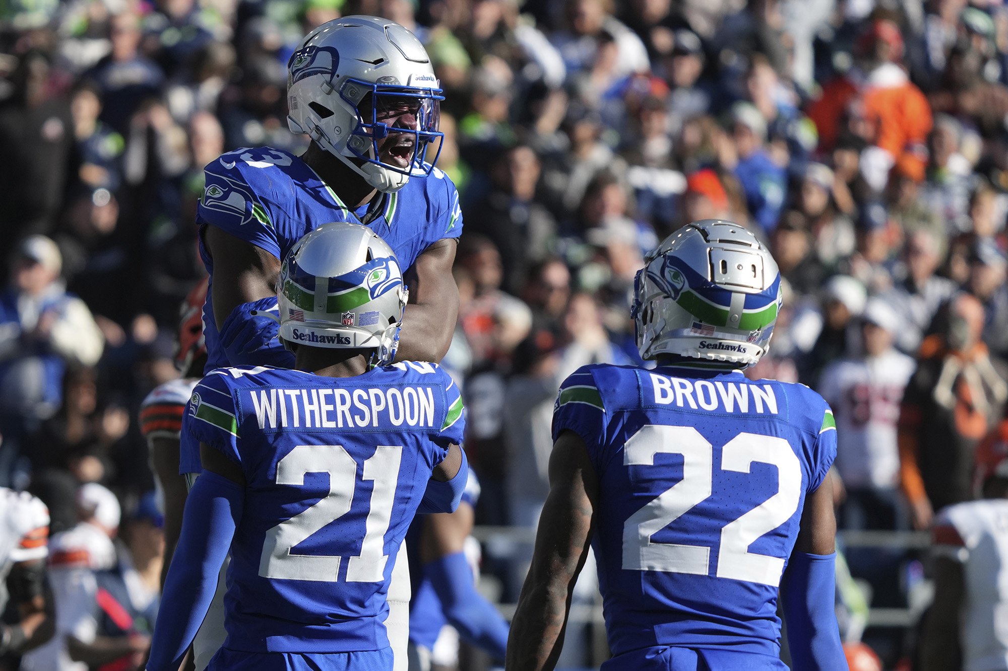 Seattle Seahawks linebacker Boye Mafe (53) celebrates with teammates Devon Witherspoon (21) and Tre Brown (22) after a sack of Cleveland Browns quarterback PJ Walker in the first half of an NFL football game, Sunday, Oct. 29, 2023, in Seattle. (AP Photo/Ted S.