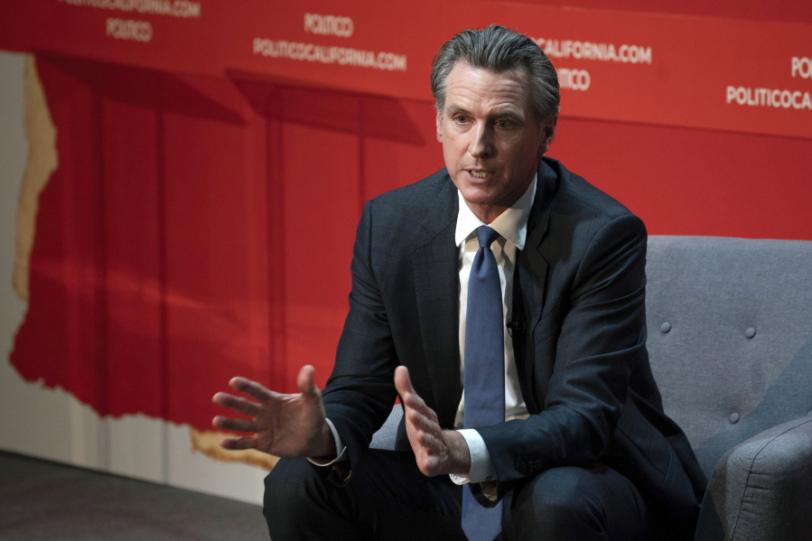 EMBARGOED HOLD FOR RELEASE - FILE - California Gov. Gavin Newsom speaks during an interview with Politico in Sacramento, Calif., Sept. 12, 2023. On Friday, Oct. 13, 2023, Newsom announced he signed a law that will increase the minimum wage for health care workers in the state.