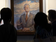 Visitors pass a portrait of President Jimmy Carter during a celebration of his 99th birthday held at The Carter Center in Atlanta on Saturday, Sept. 30, 2023.