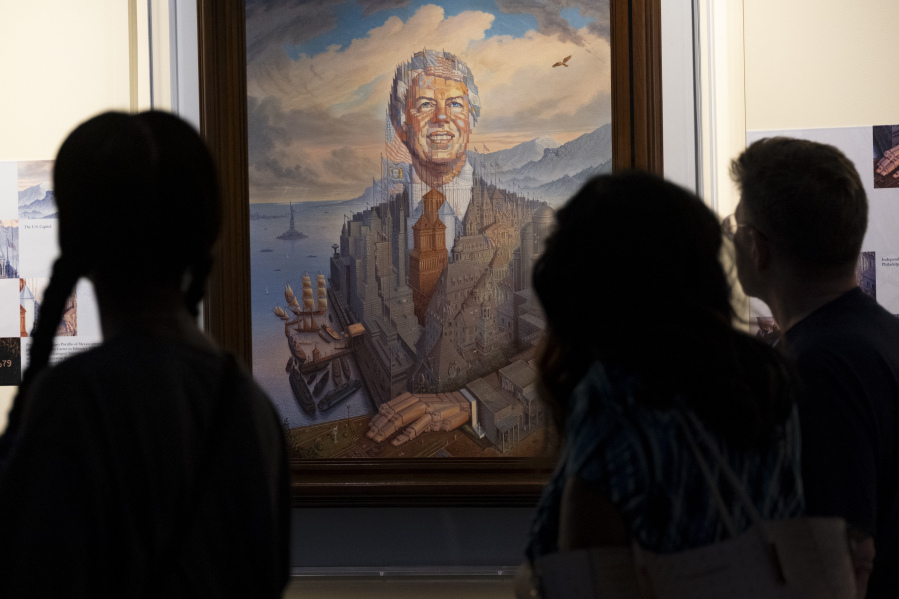 Visitors pass a portrait of President Jimmy Carter during a celebration of his 99th birthday held at The Carter Center in Atlanta on Saturday, Sept. 30, 2023.