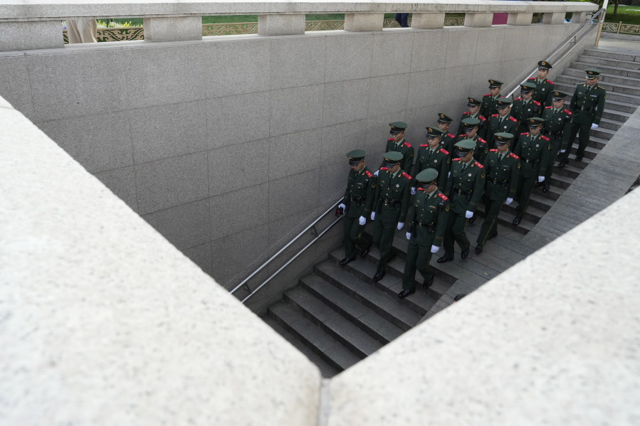 Chinese paramilitary policemen march down to an underpass as security is tighten ahead of the Belt and Road Forum to be held in Beijing, Monday, Oct. 16, 2023. A stream of leaders of emerging market countries are arriving in Beijing for a meeting organized by the Chinese government that will mark the 10th anniversary of its Belt and Road Initiative.