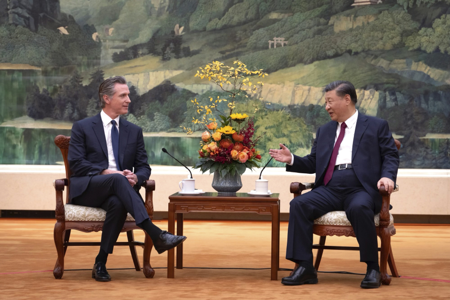 In this photo taken Wednesday, Oct 25, 2023, and released by Office of the Governor of California , California Gov. Gavin Newsom, left, meets with Chinese President Xi Jinping at the Great Hall of the People in Beijing.