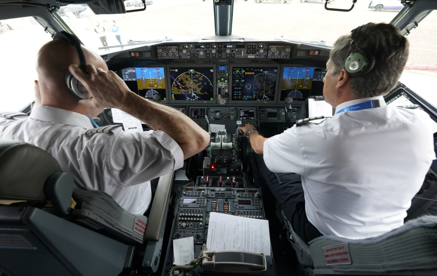 File - Pilots conduct a pre-flight check in the cockpit of a jet before taking off from Dallas Fort Worth airport in Grapevine, Texas, on Dec. 2, 2020. Aviation experts say the incident on Sunday in which an off-duty pilot, riding in a jump seat in a cockpit, tried to disable a jetliner in midflight renews questions about the threat posed by airline workers who have special access to places where passengers can't go.