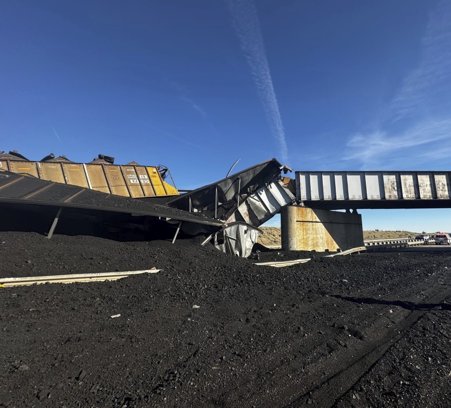 In this photo released by the Pueblo County Sheriff's Office, the wreckage of a train derailment is pictured near Pueblo, Colo., Sunday, Oct. 15, 2023. The train derailment Sunday spewed coal and mangled train cars across the highway.