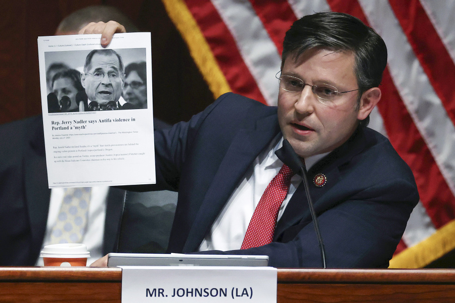 FILE - Rep. Mike Johnson, R-La., holds up an article while questioning Attorney General William Barr during a House Judiciary Committee hearing on the oversight of the Department of Justice on Capitol Hill, July 28, 2020 in Washington. Johnson, the new leader of one of the houses of Congress that will certify the winner of next year's presidential election helped spearhead the attempt to overturn the last one.