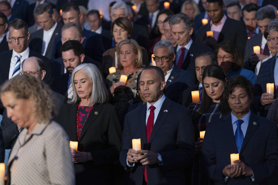Rep. Katherine Clark, D-Mass., second from left, next to House Minority Leader Hakeem Jeffries D-N.Y., have a moment of silence along with other members of Congress as they host a candlelight vigil for Israel at the Capitol in Washington, Thursday, Oct. 12, 2023.