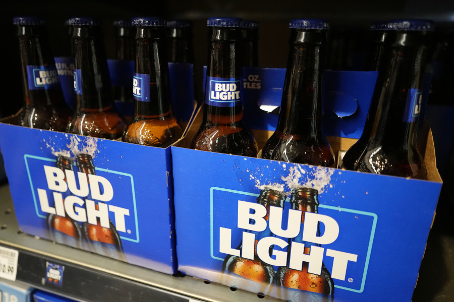 FILE - Bottles of Bud Light beer are seen at a grocery store in Glenview, Ill., Tuesday, April 25, 2023. Anheuser-Busch Inbev said Tuesday, Oct. 31, 2023, that revenue growth in most of its global regions was offset by a drop in North American sales, in a sign of continuing fallout from a promotion with a transgender influencer that cost it sales. The world's largest brewer and parent company of Bud Light said adjusted earnings for the latest quarter rose 4.1% to $5.4 billion on revenues that climbed 5% to $15.6 billion.  (AP Photo/Nam Y.