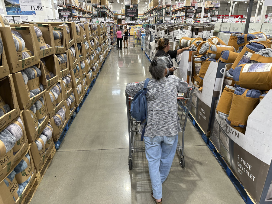 File - Shoppers look over blankets on sale in a Costco warehouse on Aug. 24, 2023, in Sheridan, Colo. On Thursday, the Commerce Department issues its first of three estimates of how the U.S. economy performed in the third quarter of 2023.