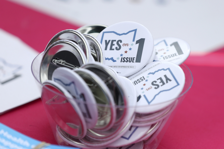 FILE - Buttons in support of Issue 1, the Right to Reproductive Freedom amendment, sit on display at a rally held by Ohioans United for Reproductive Rights at the Ohio Statehouse in Columbus, Ohio, Oct. 8, 2023. As campaigning escalates in Ohio's fall fight over abortion rights, a new line of attack from opponents suggests "partial-birth" abortions would be revived if a proposed constitutional amendment passes.