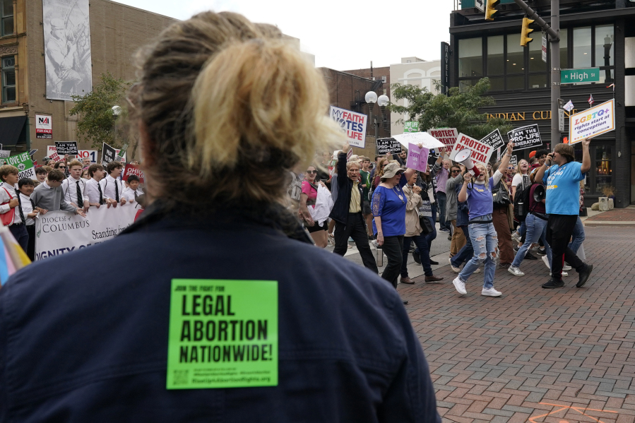Marchers shout to a counter-protester calling for legal abortion nationwide as they move down High Street during the Ohio March for Life after a rally at the Ohio State House in Columbus, Ohio, Friday, Oct. 6, 2023.