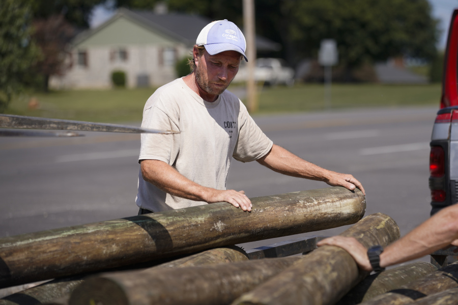 Mark Cook loads lumber onto a trailer, Tuesday, Oct. 3, 2023, in Bowling Green, Ky. Voters across Kentucky are making their choices ahead of the Nov. 7 gubernatorial showdown between Democratic Gov. Andy Beshear and his GOP challenger, Daniel Cameron.