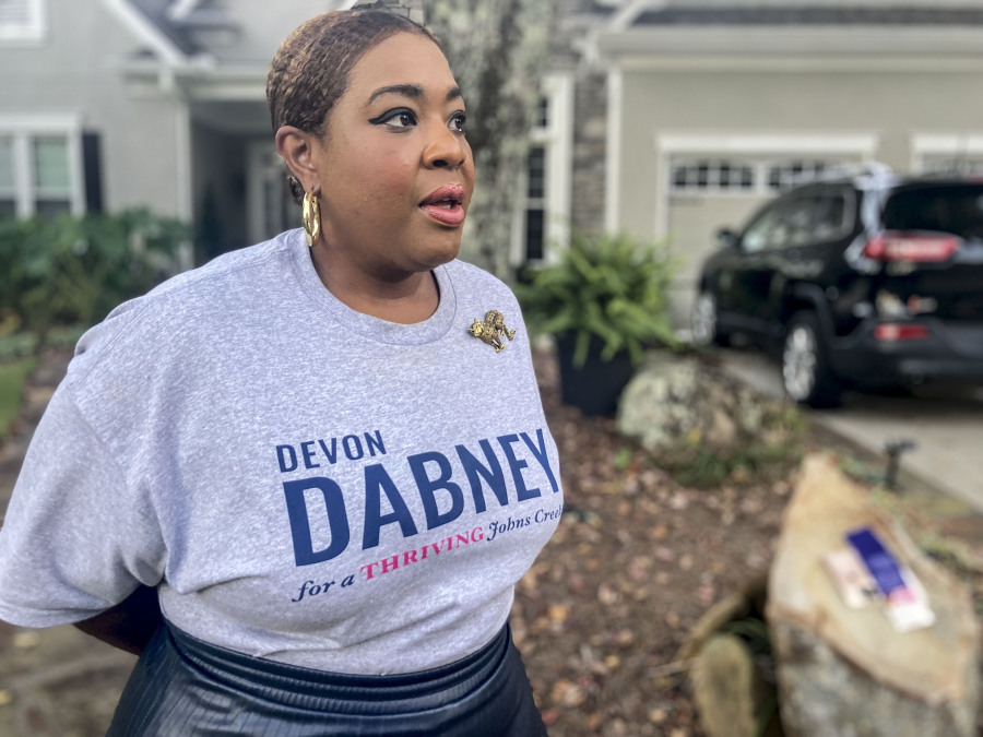 Devon Dabney, a candidate for city council in Johns Creek, Ga., stands outside her home and discusses her candidacy on Monday, Oct. 23, 2023. The contest is nonpartisan and Dabney calls herself an independent, but she faces criticism from some voters in this historically Republican-leaning enclave because she says she has voted for Democrats in the past. The political dynamics in some of Atlanta's suburbs reflect how partisan and cultural divisions have trickled down to local campaigns.
