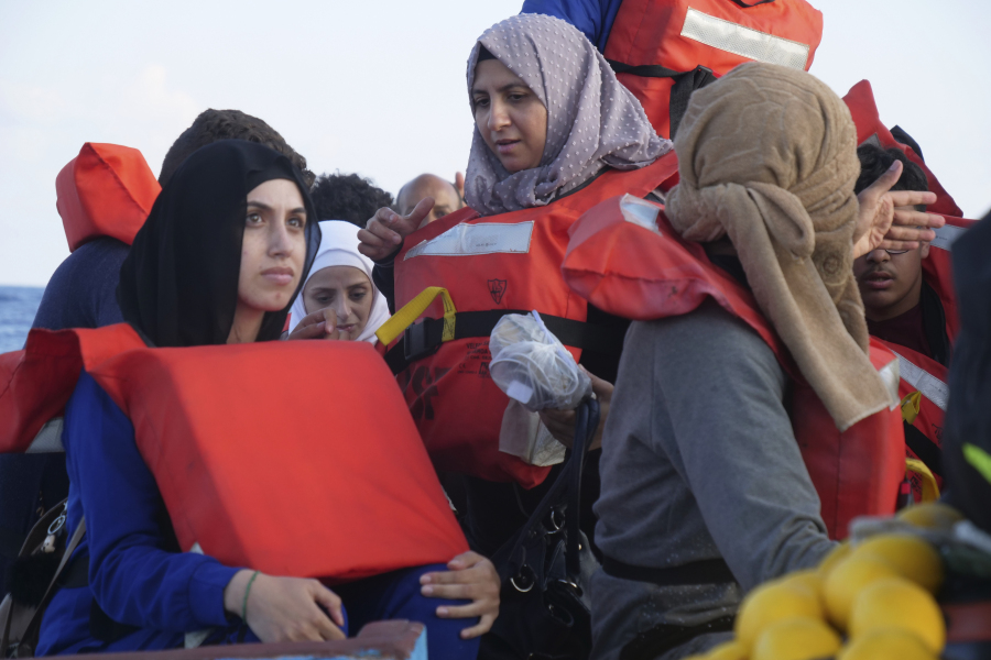 Migrants wear life vests as they are rescued by a MSF (Medecins Sans Frontiers) rescue team boat, after leaving Libya trying to reach European soil, in the Mediterranean Sea, Friday, Oct. 6, 2023.