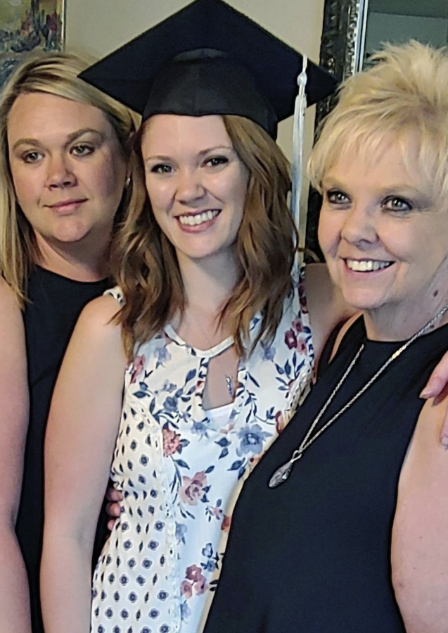 Brianna Hayes, center, poses with her older sister Darci Hayes, left, and mother Sharon Hayes, right, in June 2019 after graduating from her graduate school program at Eastern Washington University in Cheney, Wash. Sharon Hayes, of Hauser, Idaho, sued her former fertility doctor in Spokane on Wednesday, Oct. 25, 2023, saying that he secretly used his own sperm to inseminate her when she became pregnant with her second daughter 34 years ago - information Brianna Hayes said she discovered after taking an at-home DNA test.