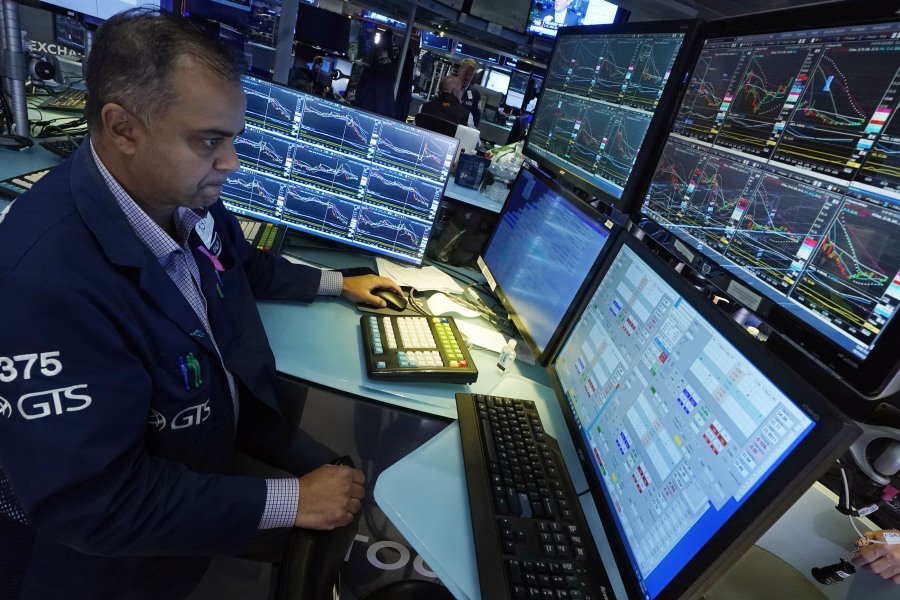 Specialist Dilip Patel works at his post on the floor of the New York Stock Exchange, Tuesday, Oct. 3, 2023. Wall Street is sinking sharply as it focuses on the downside of a surprisingly strong job market.