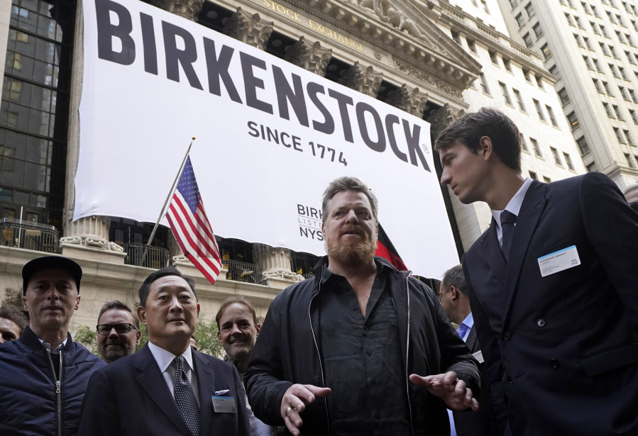 L. Catterton co-CEO, Michael Chu, second from left, Birkenstock CEO Oliver Reichert, second from right, and Alexandre Arnault, of LVMH, right, pose for photos outside the New York Stock Exchange, prior to the Birkenstock IPO, Wednesday, Oct. 11, 2023.