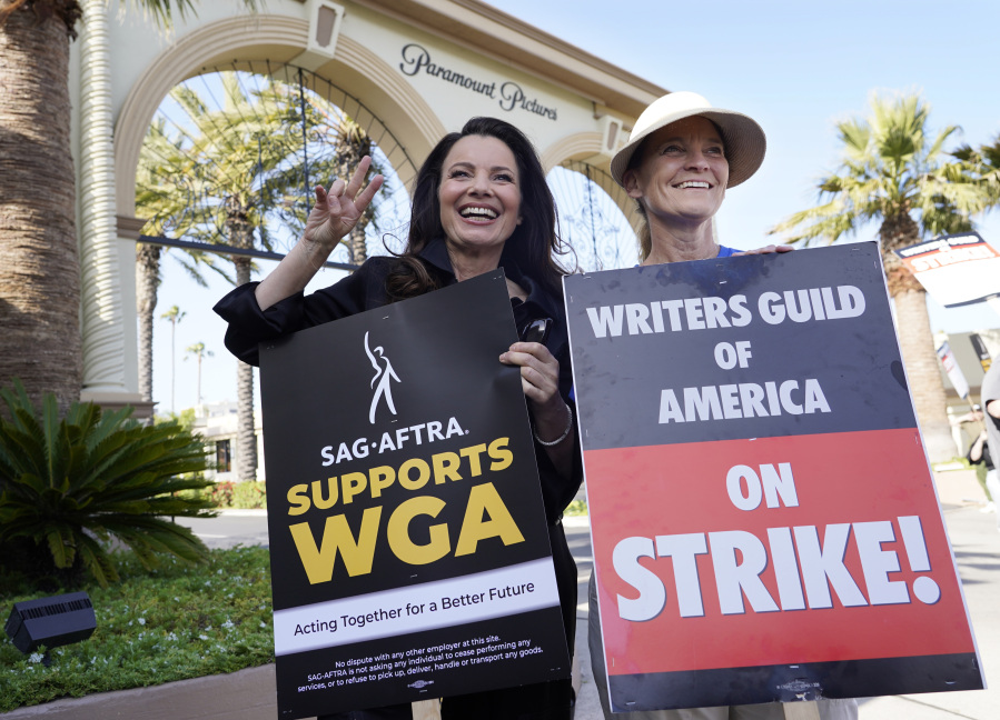 FILE - Fran Drescher, left, president of SAG-AFTRA, and Meredith Stiehm, president of Writers Guild of America West, pose together during a rally by striking writers outside Paramount Pictures studio in Los Angeles on May 8, 2023.