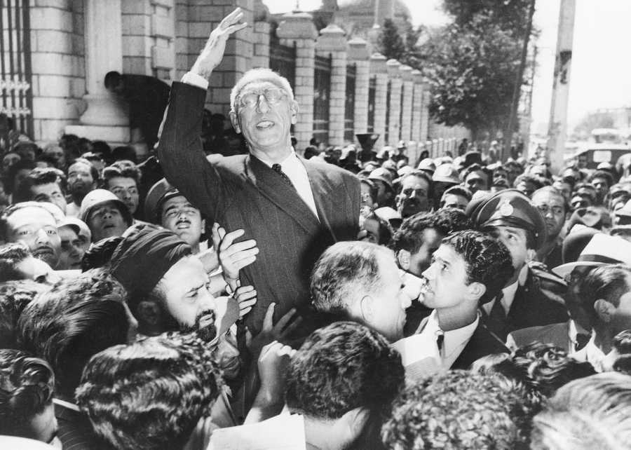 FILE - Prime Minister Mohammad Mossadegh rides on the shoulders of cheering crowds in Tehran's Majlis Square, outside the parliament building, after reiterating his oil nationalization views to his supporters on Sept. 27, 1951. While revealing new details about one of the most famed CIA operations of all times, the spiriting out of six American diplomats who escaped the 1979 U.S. Embassy seizure in Iran, the intelligence agency for the first time has acknowledged something else as well. The CIA now officially describes the 1953 coup it backed in Iran that overthrew its prime minister and cemented the rule of Shah Mohammad Reza Pahlavi as undemocratic.