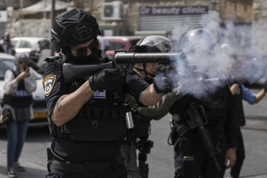 Israeli security forces shoot tear gas canisters towards Palestinians during riots near Jerusalem's Old City, Friday, Oct. 27, 2023.