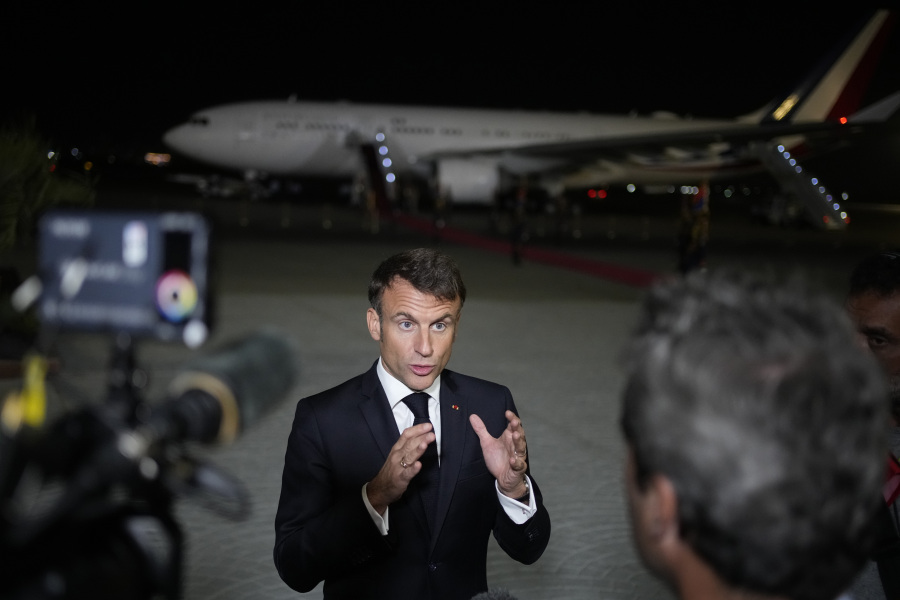 French President Emmanuel Macron talks to journalists on the tarmac of Cairo airport, Egypt, as he departs Wednesday, Oct. 25, 2023. French President Emmanuel Macron sought to promote, yet with little success, the prospect of creating an "international coalition" to fight against the armed Palestinian militant group Hamas, during a two-day trip to the Middle East that started in Israel.