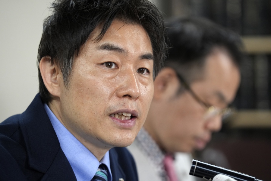 Lawyers of a claimant, Kazuyuki Minami, left, and Masafumi Yoshida, right, speak to media after the ruling of the Supreme Court Wednesday, Oct. 25, 2023, in Tokyo.