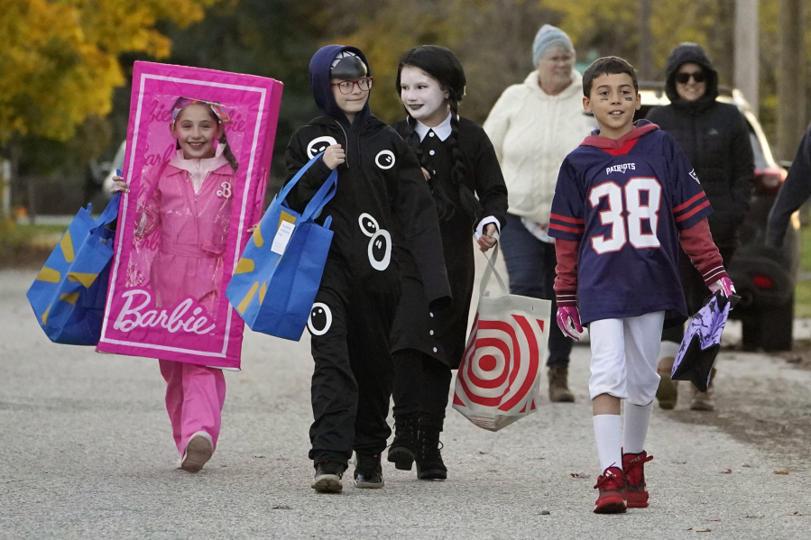 Halloween brings smiles to the faces of trick-or-treaters in the wake of last week's mass shootings, Tuesday, Oct. 31, 2023, in Lewiston, Maine. (AP Photo/Robert F. Bukaty) (robert f.