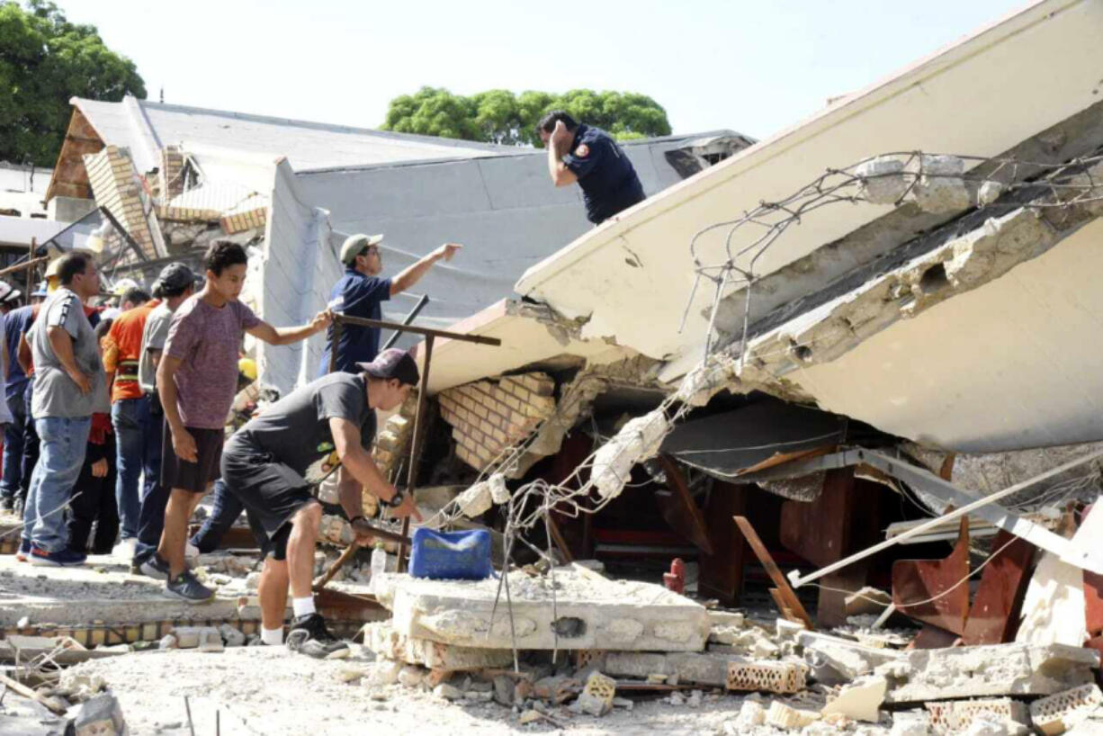 Rescue workers search for survivors amid debris after the roof of a church collapsed during a Sunday Mass in Ciudad Madero, Mexico, Sunday, Oct. 1, 2023. The Bishop of the Roman Catholic Diocese of Tampico said the roof caved in while parishioners were receiving communion.