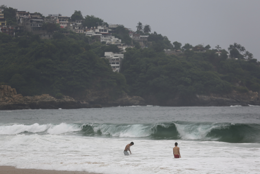Tourists swim in Acapulco, Mexico, Tuesday, Oct. 24, 2023. Hurricane Otis has strengthened from tropical storm to a major hurricane in a matter of hours as it approaches Mexico's southern Pacific coast where it was forecast to make landfall near the resort of Acapulco early Wednesday.