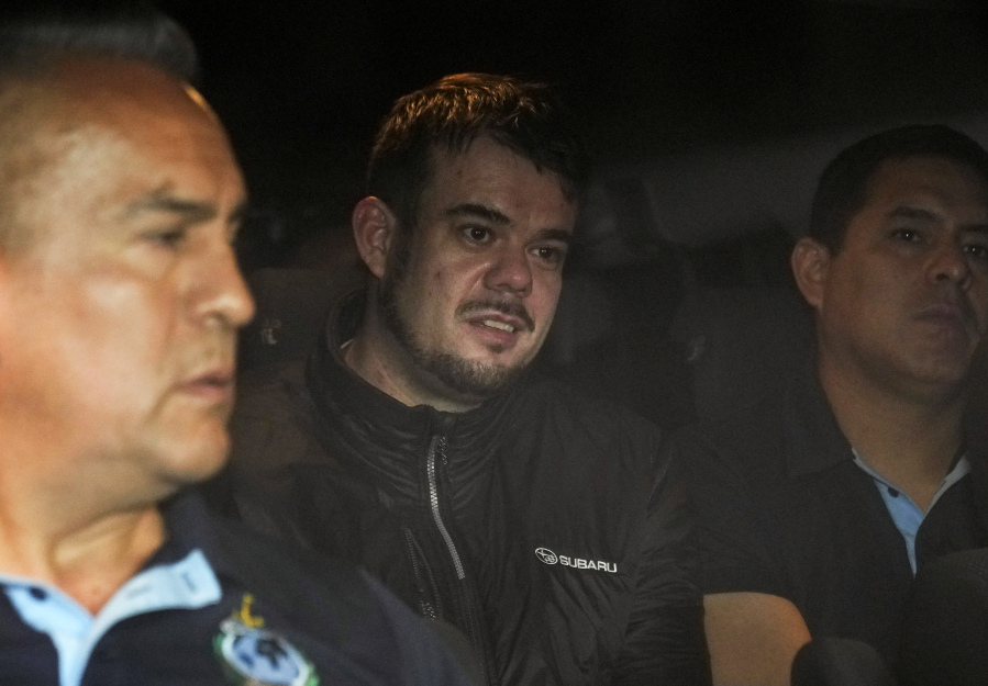 FILE - Dutch citizen Joran van der Sloot is driven in a police vehicle from a maximum-security prison to an airport to be extradited to the U.S., on the outskirts of Lima, Peru, Thursday, June 8, 2023. Van der Sloot, the chief suspect in Natalee Holloway's 2005 disappearance, is scheduled to appear in court Wednesday morning, Oct. 18, where he is expected to plead guilty to trying to extort money from her mother and provide new information about what happened to the missing teen.