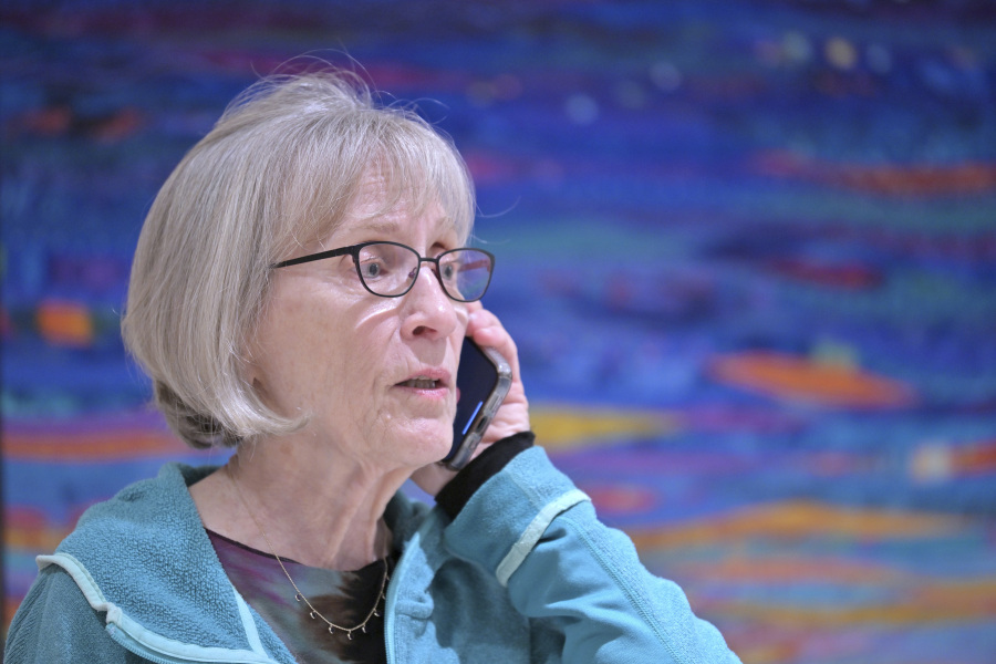 Claudia Goldin speaks to a reporter on the phone in her home in Cambridge, Mass. after learning that she received the Nobel Prize in Economics Monday, Oct. 9, 2023. Goldin, a professor at Harvard University, for advancing understanding of women's labor market outcomes.