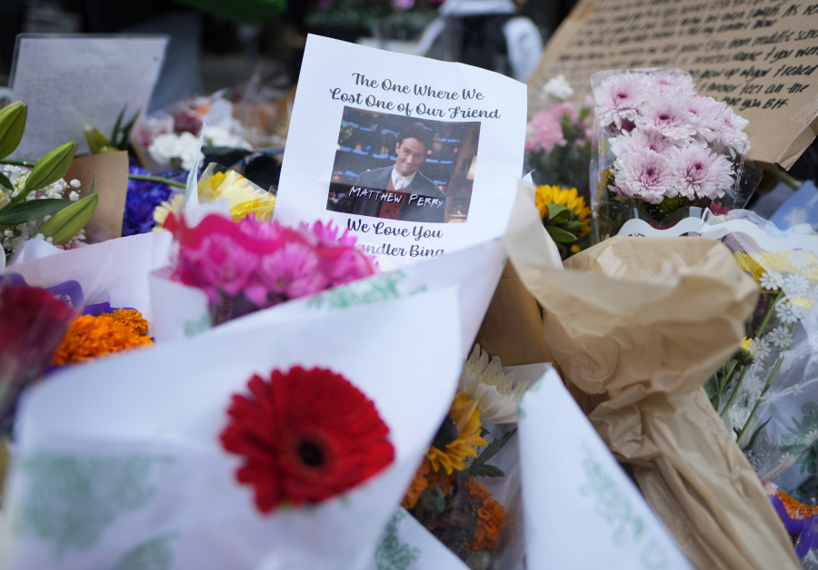 A makeshift memorial for Matthew Perry is seen outside the building shown in exterior shots of the television show "Friends" on Monday, Oct. 30, 2023, in New York. Perry, who played Chandler Bing on NBC's "Friends" for 10 seasons, was found dead at his Los Angeles home on Saturday. He was 54.